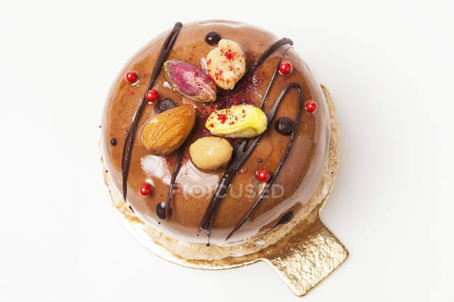 Um grande macaron, decorado com chocolate e nozes — Fotografia de Stock