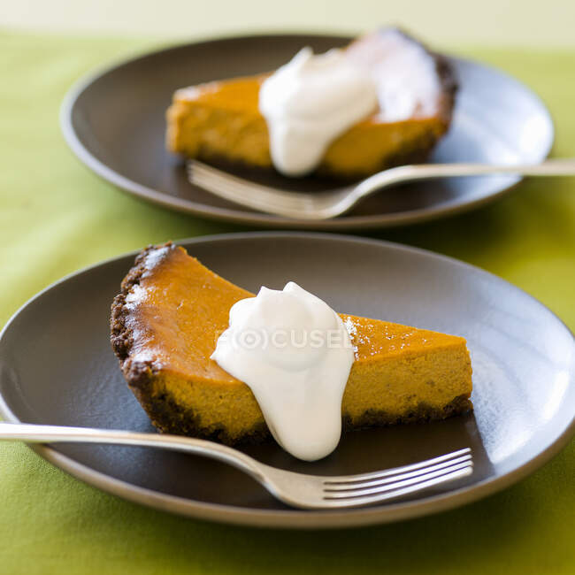Two slices of pumpkin pie with whipped cream — Stock Photo