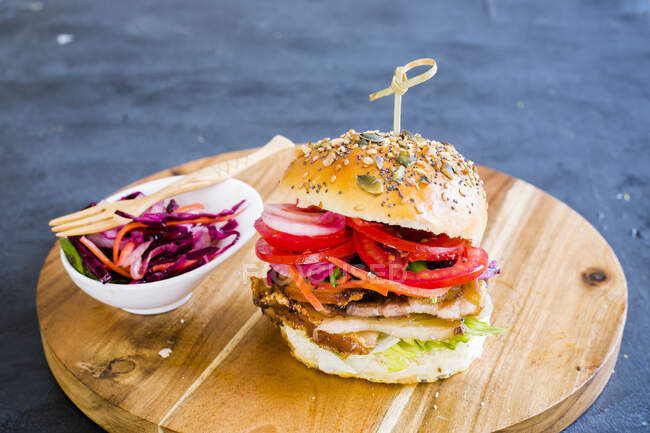 A schnitzel sandwich with pickled vegetables — Stock Photo