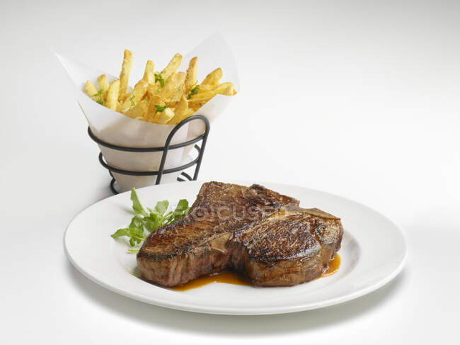 A porterhouse steak with french fries — Stock Photo