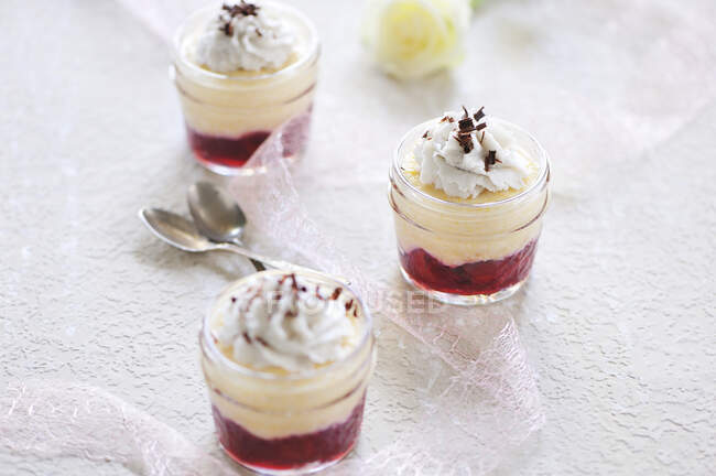 Semolina yoghurt-cream in jars with cherries and coconut cream (vegan) — Stock Photo