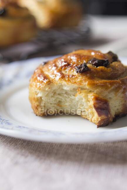 A cinnamon and raisin swirl with a bite out of it — Stock Photo