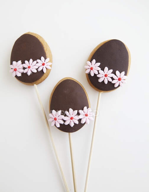 Three Decorated Easter Egg shaped cookies on a stick — Stock Photo
