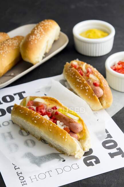 Mini hot dogs in homemade buns with mustard — Stock Photo
