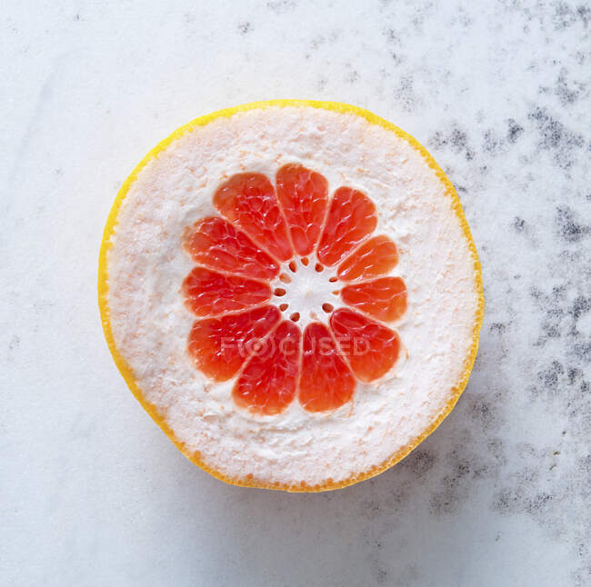 Half of grapefruit with large peel — Stock Photo