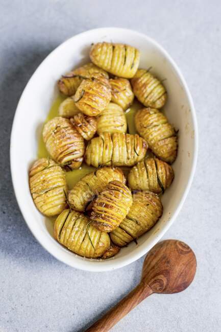 Hasselback potatoes with rosemary — Stock Photo