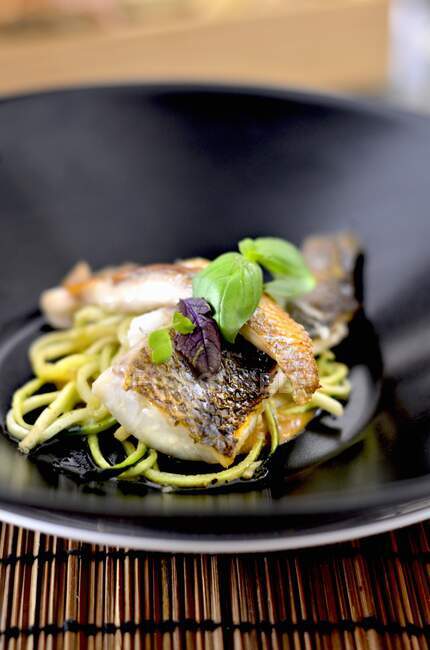 Fried sea bass with zoodles — Stock Photo