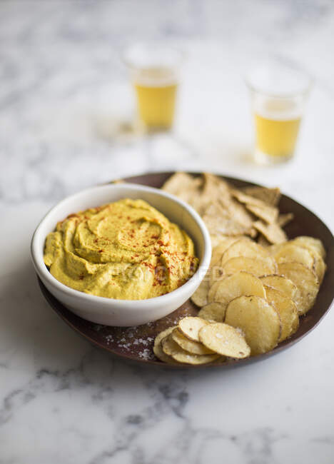 Vegan cheese dip with crisps served on plate — Stock Photo