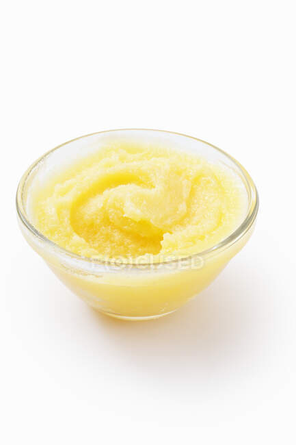 Ghee in a glass bowl on a white surface — Stock Photo