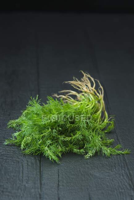 Fresh dill on a black background — Stock Photo