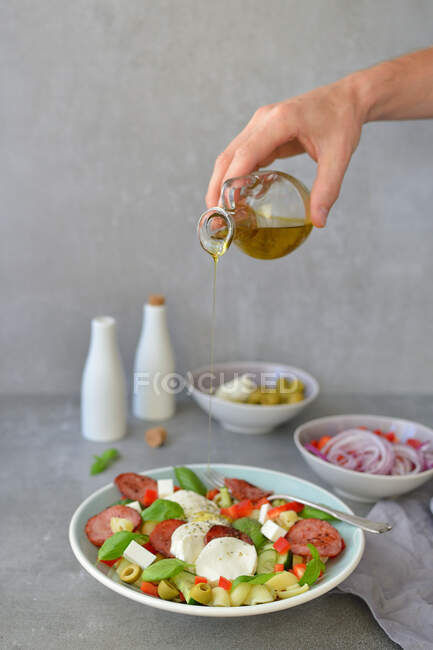 Italian-style pasta salad with olive oil basil mozzarella and olives — Photo de stock