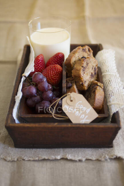 Breakfast with banana bread, fruit and milk — Stock Photo