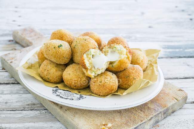 Fried potato balls with cheese filling served on plate — Stock Photo