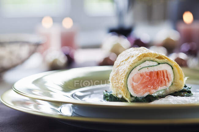 Salmon strudel on spinach for Christmas — Stock Photo