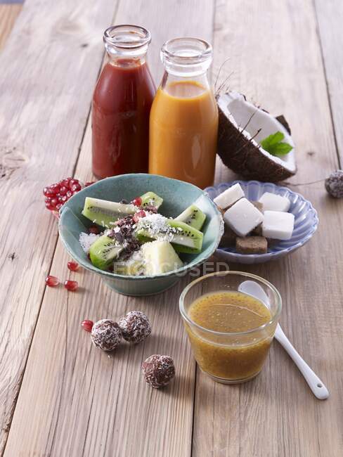 Smoothies with fruit salads and coconut balls — Stock Photo
