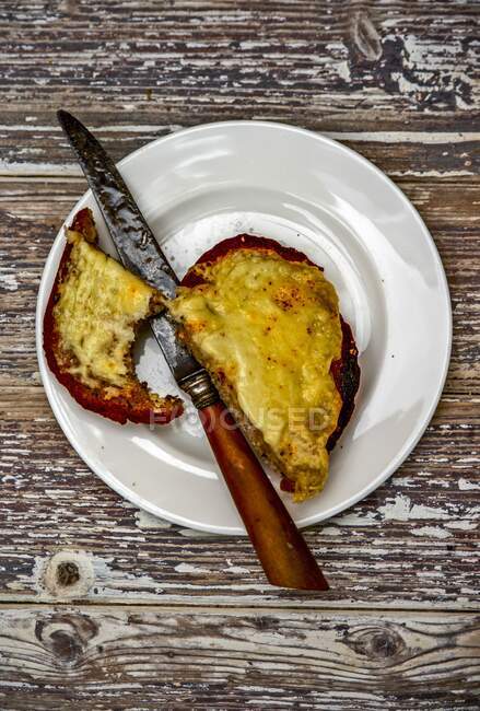Cheese on toast with a bite out of it — Stock Photo
