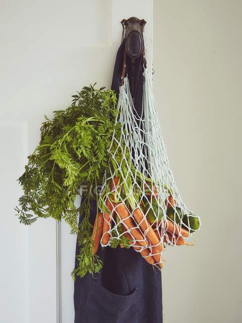 Carrots in shopping bag — Stock Photo
