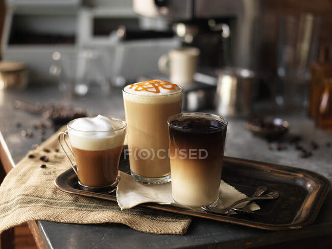 Various coffee drinks on a tray — Stock Photo