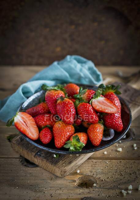Fresas frescas en tazón con paño azul - foto de stock