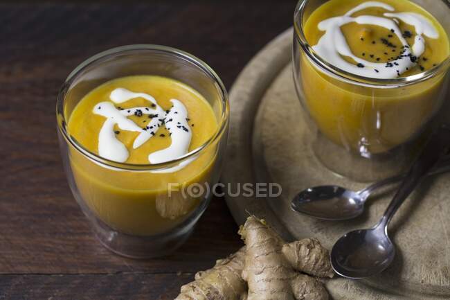 Carrot soup with creme frache and black salt — Stock Photo