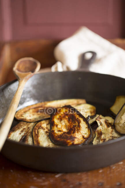Aubergine slices being fried in oil — Stock Photo