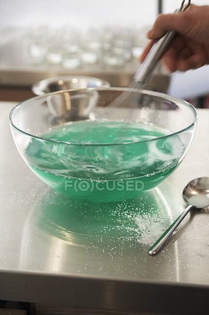 Whisking a jelly mixture — Stock Photo