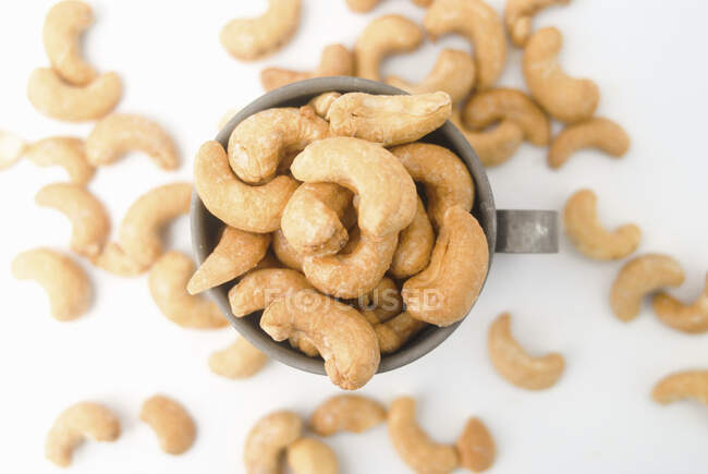 Cashew kernels in a metal cup — Stock Photo