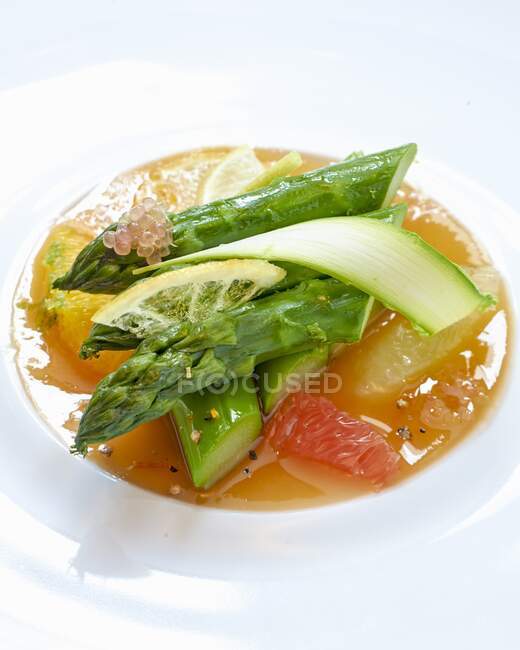 Asparagus on citrus fruit jelly — Stock Photo