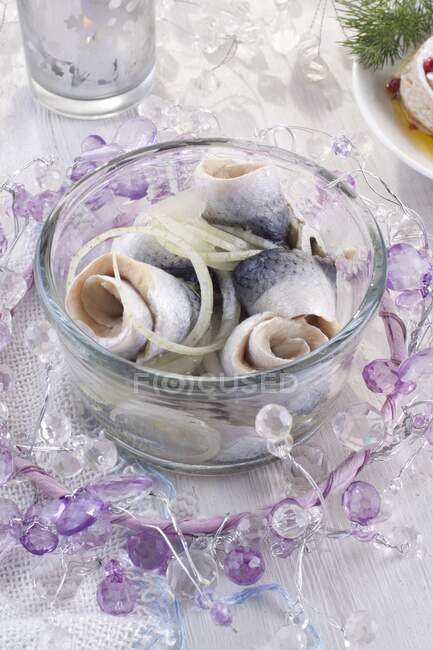Rollmops (pickled herring fillets) with onion for Christmas — Stock Photo