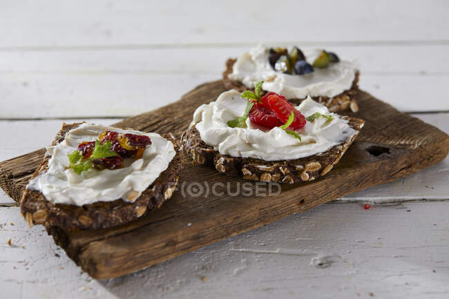 Wholemeal bread topped with cream cheese and fruit (vegan) — Stock Photo