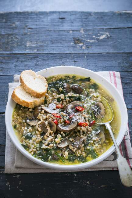 Spelt and mushroom soup with chard and chili — Stock Photo