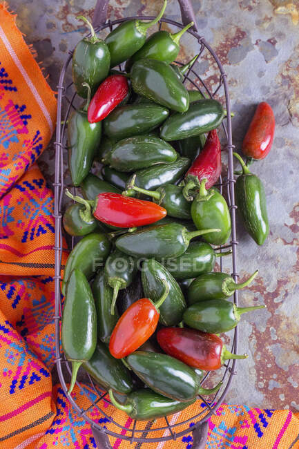 Fresh jalapenos in a wire basket — Stock Photo