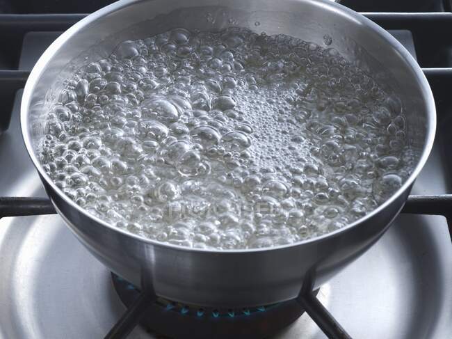 Sugar boiling in a bowl — Stock Photo