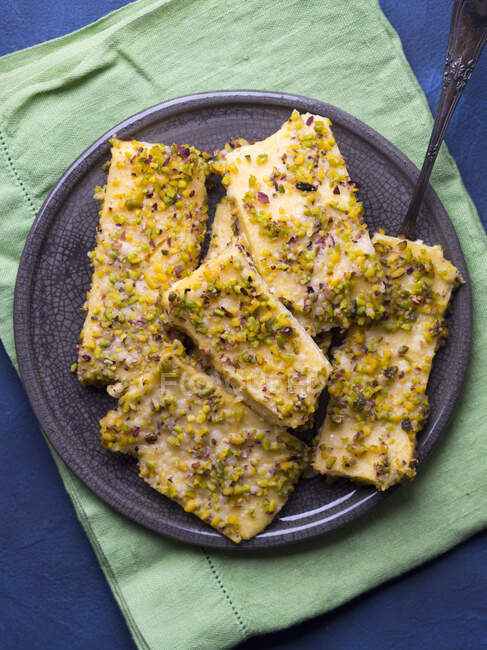 Baked polenta cheese bars topped with pistachio nuts and Parmesan — Stock Photo