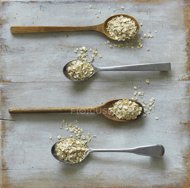 Four spoons of oats — Stock Photo