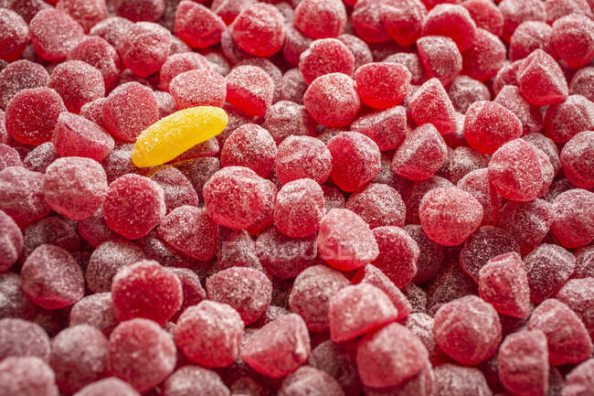 Red gumdrops and a single yellow gumdrop (filling the picture) — Stock Photo