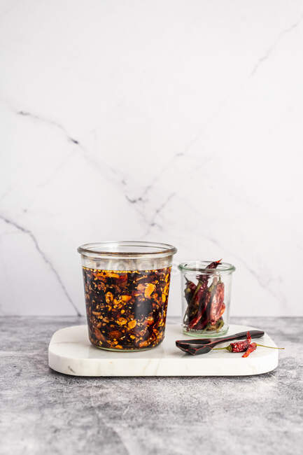 Homemade Chili Crisp - oil-based Chinese condiment made of pepper flakes, fried garlic, and fermented soybeans — Stock Photo