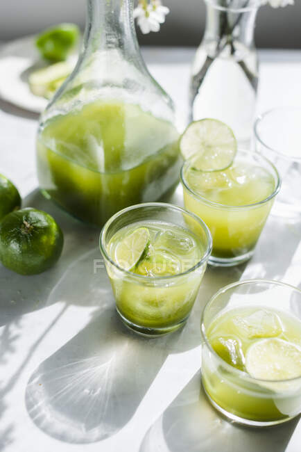 Gin cocktail with apple, spinach and lime in glasses — Stock Photo
