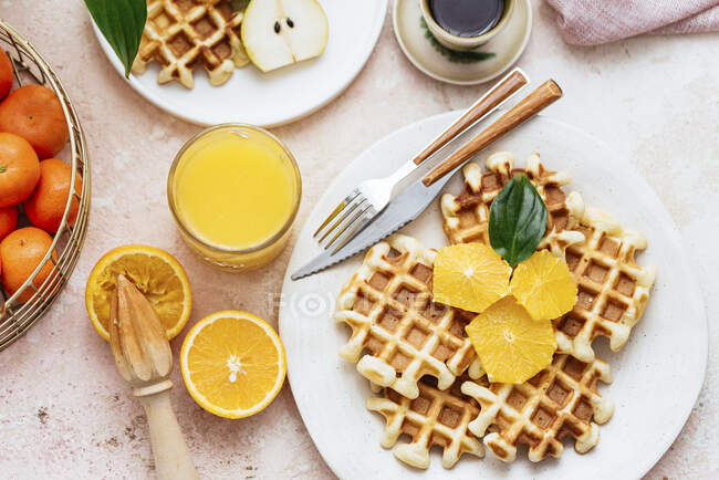 Homemade waffles with orang juice, top view — Stock Photo