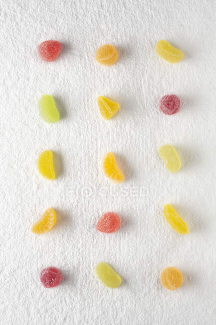 Gumdrops, lined up on a white background — Stock Photo