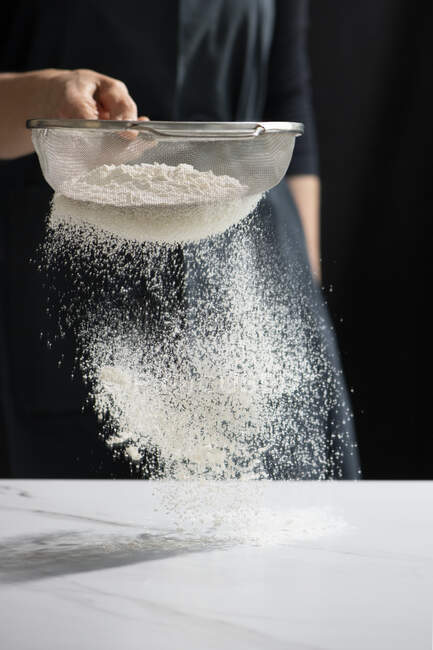 Sifting flour close-up view — Stock Photo