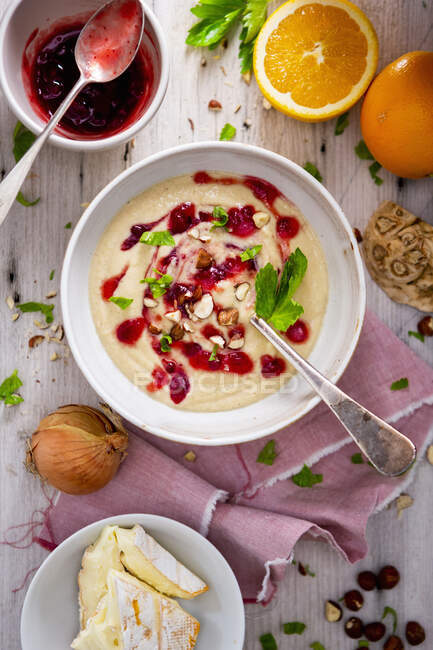 Celery camembert soup with cranberries — Stock Photo