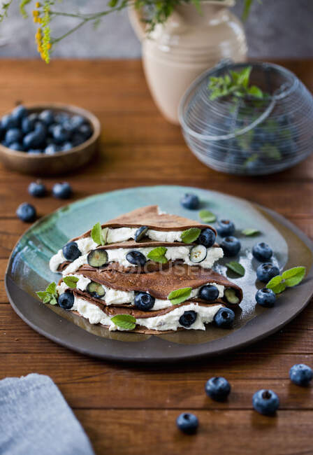 Chocolate pancakes with mascarpone and berries — Stock Photo