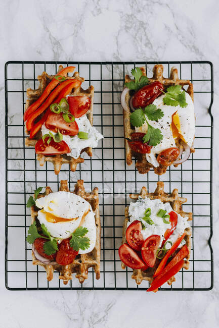 Savoury waffled with poached eggs and vegetables — Stock Photo