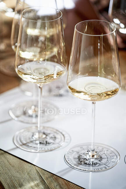 Copas de vino blanco, alineadas para la degustación de vinos - foto de stock