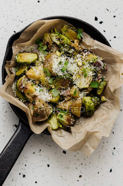 Potatoes and Brussels sprouts in parchment paper — Stock Photo