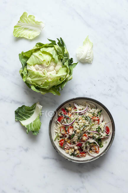 Fresh green salad with vegetables and herbs on a white background. top view. — Stock Photo