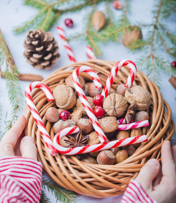 Candycanes and Christmas wreath with nuts — Stock Photo