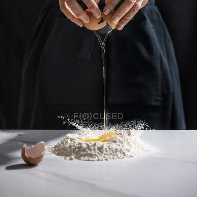 Making pasta dough, closeup of persons hands - foto de stock