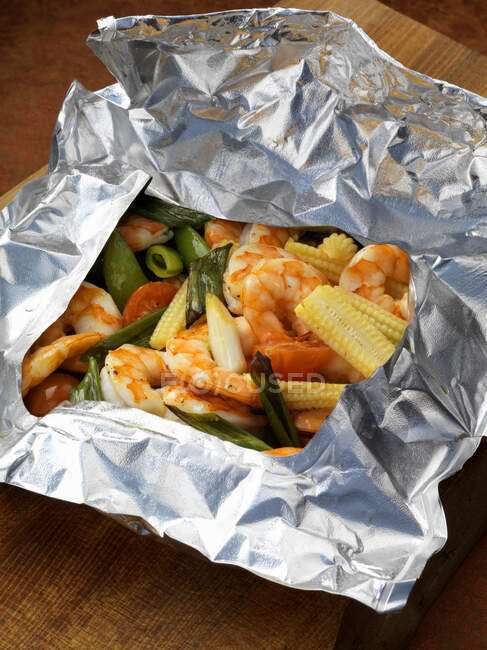 Crevettes et légumes cuits à la vapeur dans du papier d'aluminium — Photo de stock